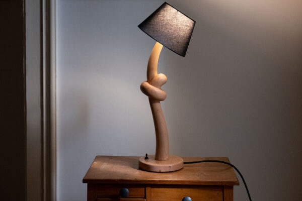 Knotted lamp, a hand-carved wooden lamp with a knotted stem. Designed and crafted by Arcangelo Ambrosi