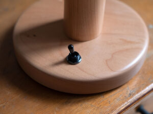Knotted lamp, a hand-carved wooden lamp with a knotted stem. Designed and crafted by Arcangelo Ambrosi