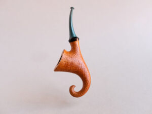 Pixie, a signature model pipe made of snadblasted briar with a green stem, created by Arcangelo Ambrosi
