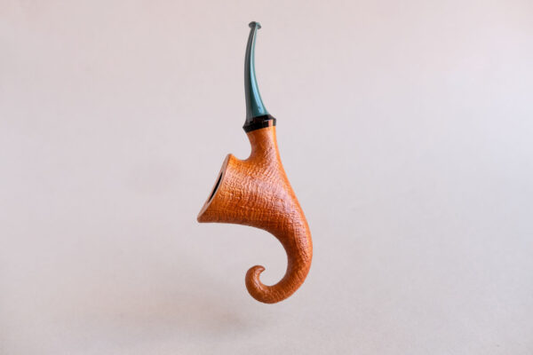 Pixie, a signature model pipe made of snadblasted briar with a green stem, created by Arcangelo Ambrosi