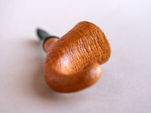 Pixie, a signature model pipe made of snadblasted briar with a green stem, created by Arcangelo Ambrosi