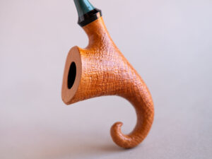 Pixie, a signature model pipe made of snadblasted briar with a green stem, created by Arcangelo Ambrosi