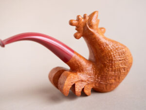 Singing rooster sculptural pipe crafted by Arcangelo Ambrosi and made of natural sandblasted briar and red ebonite stem
